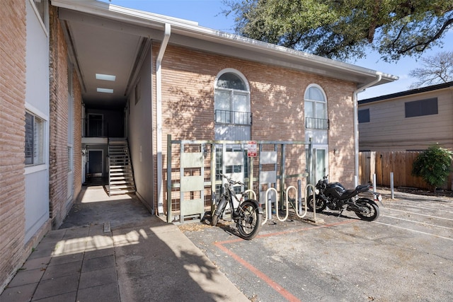 exterior space with brick siding and fence