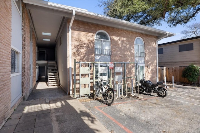 2208 Enfield Rd Unit 207, Austin, TX 78703 - view of front facade with brick siding, fence, and stairway