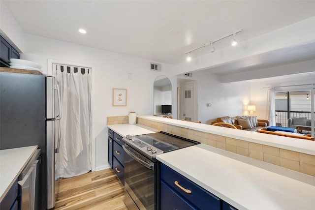 kitchen with light wood-style flooring, open floor plan, blue cabinets, stainless steel appliances, and light countertops