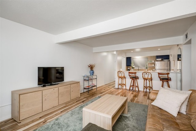 2208 Enfield Rd Unit 207, Austin, TX 78703 - living area with light wood-style floors, bar, and arched walkways