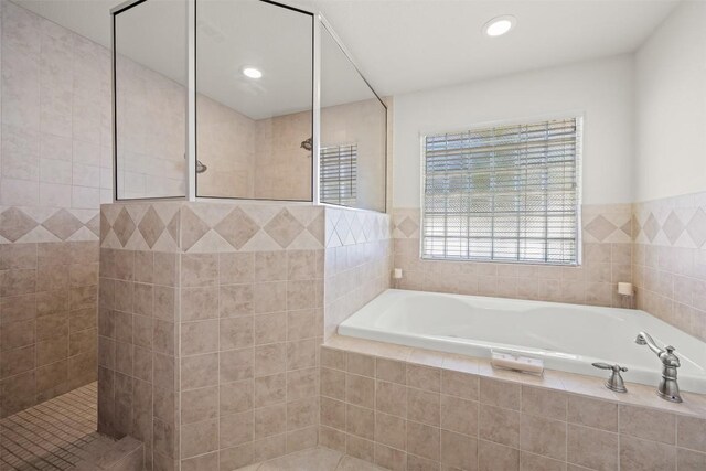 bathroom featuring separate shower and tub