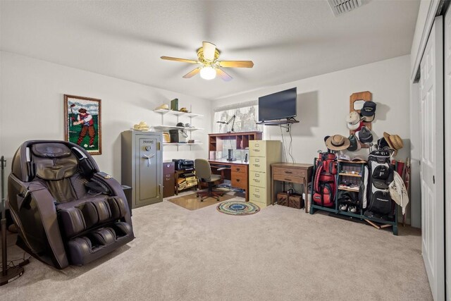 office area featuring carpet, ceiling fan, and a textured ceiling