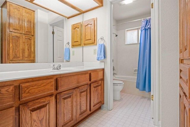 full bathroom featuring toilet, vanity, and shower / tub combo with curtain