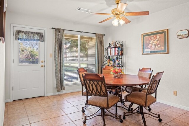 dining area with ceiling fan and light tile patterned floors