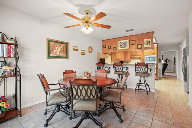 dining room featuring ceiling fan and light tile patterned flooring