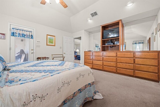 carpeted bedroom featuring ceiling fan and vaulted ceiling