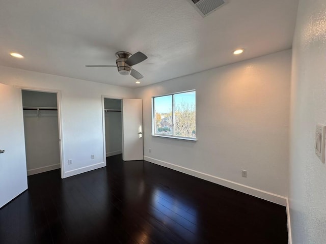 unfurnished bedroom featuring dark hardwood / wood-style floors and ceiling fan