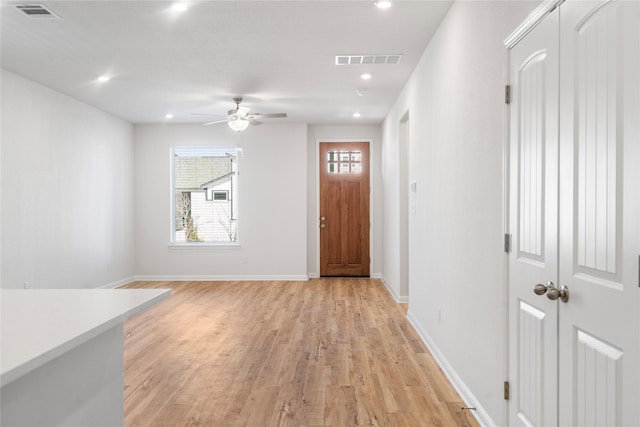 entryway with ceiling fan and light hardwood / wood-style flooring