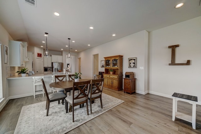 dining room with recessed lighting, light wood-style floors, visible vents, and baseboards