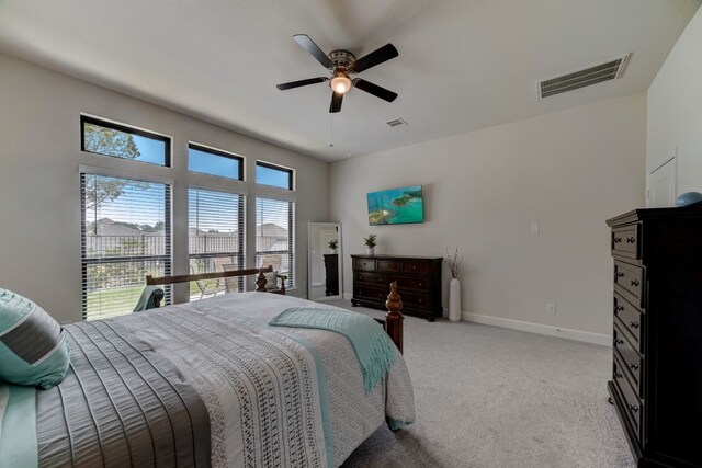 bedroom featuring visible vents, light carpet, baseboards, and a ceiling fan