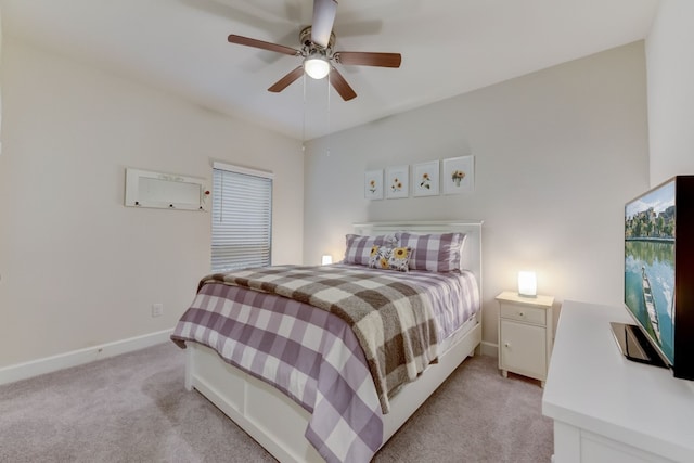 bedroom with ceiling fan, baseboards, and light carpet