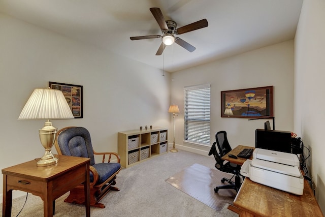 carpeted office with baseboards and a ceiling fan