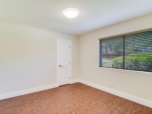 spare room with hardwood / wood-style floors