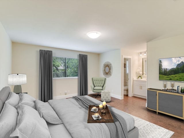 bedroom with dark hardwood / wood-style floors and ensuite bathroom