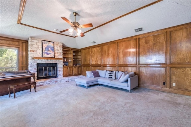 living room with wood walls, light colored carpet, a fireplace, and vaulted ceiling