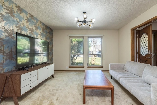 living room with light carpet, a textured ceiling, and a notable chandelier