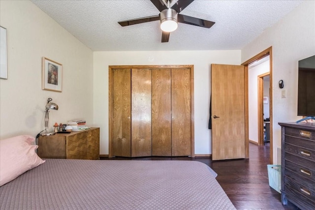 bedroom featuring a textured ceiling, a closet, ceiling fan, and dark hardwood / wood-style floors