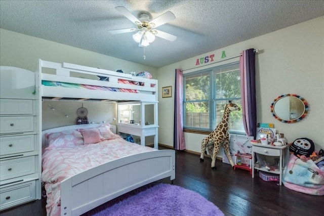 bedroom with ceiling fan, dark hardwood / wood-style floors, and a textured ceiling