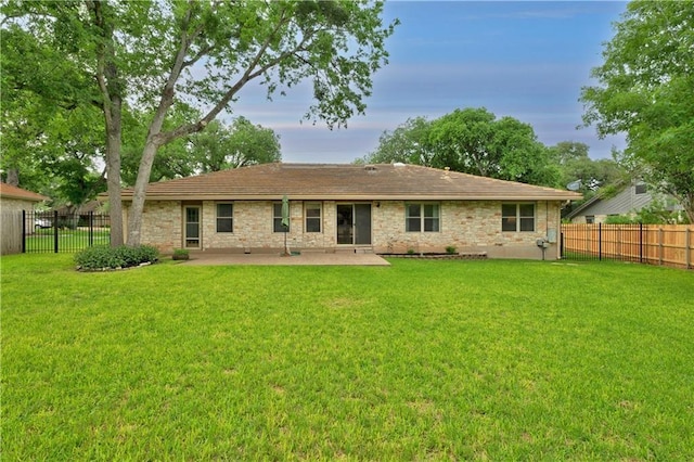 back of house featuring a lawn and a patio area