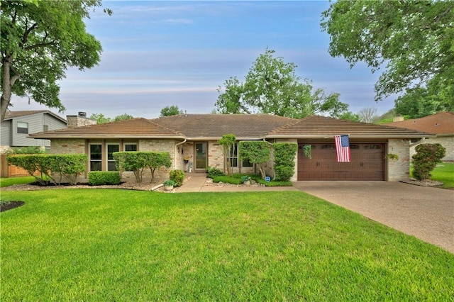 ranch-style home with a garage and a lawn