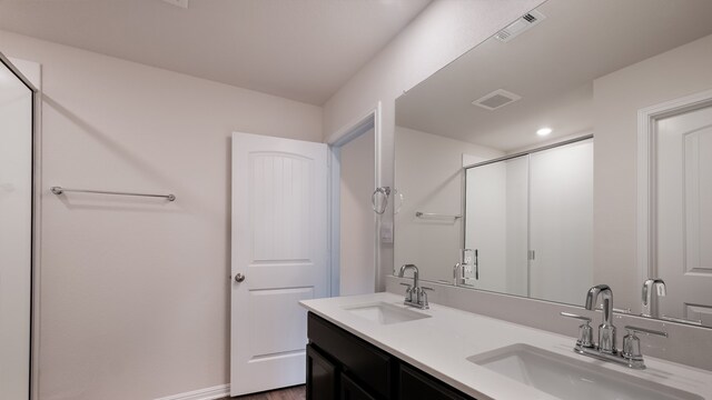 bathroom featuring hardwood / wood-style floors, vanity, and an enclosed shower