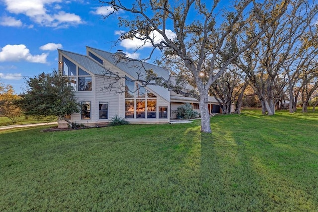 318 Coventry Rd, Spicewood, TX 78669 - back of property with a lawn, a chimney, and metal roof