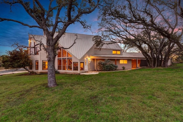318 Coventry Rd, Spicewood, TX 78669 - back of property at dusk featuring a yard and metal roof