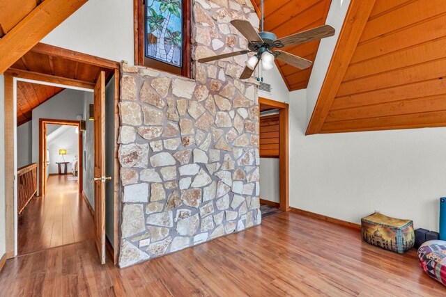 unfurnished living room with ceiling fan, light hardwood / wood-style floors, lofted ceiling, and wooden ceiling