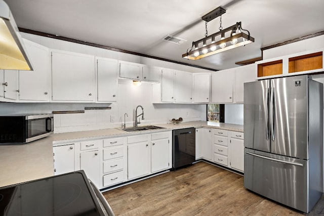 kitchen featuring pendant lighting, stainless steel appliances, white cabinetry, and sink