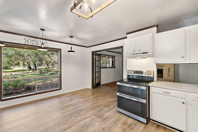 kitchen with white cabinetry, pendant lighting, stainless steel electric range oven, and light wood-type flooring