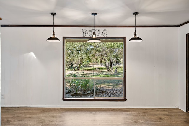 interior space with wood-type flooring and ornamental molding