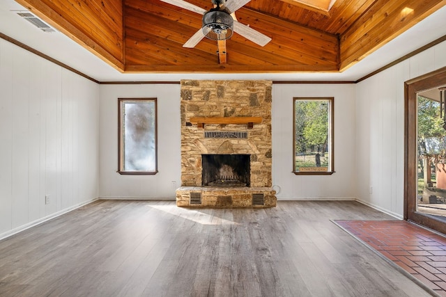 unfurnished living room with a raised ceiling, a stone fireplace, ceiling fan, and wooden ceiling