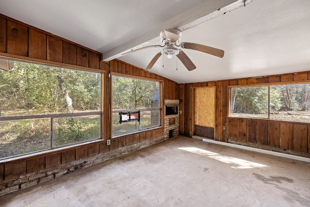 unfurnished sunroom with ceiling fan and lofted ceiling with beams