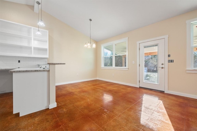 unfurnished dining area with a chandelier and lofted ceiling