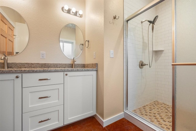 bathroom with tile patterned floors, vanity, and an enclosed shower