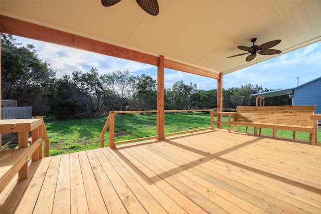 deck with ceiling fan and a yard