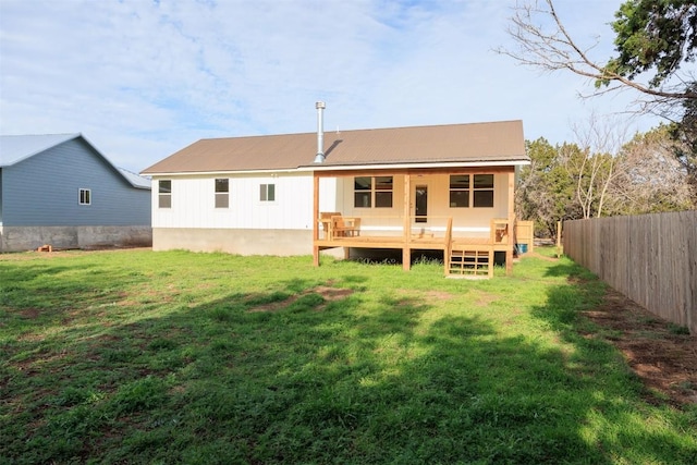 rear view of property with a lawn and a wooden deck