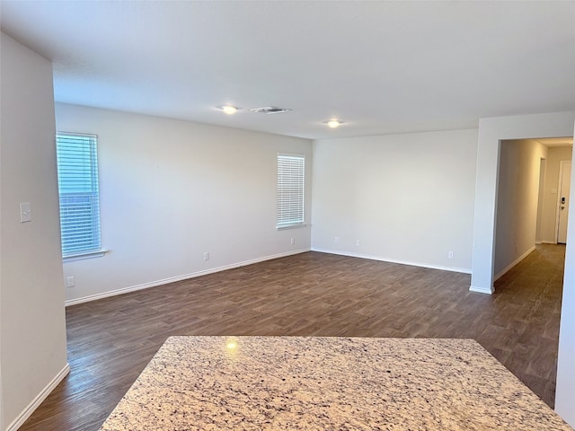 empty room featuring dark wood-type flooring