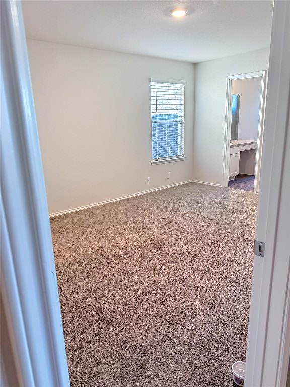 unfurnished room featuring carpet