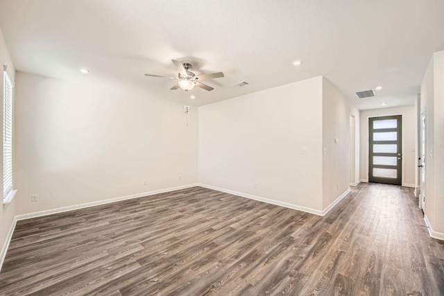 188 Weaver Ln, Bastrop, TX 78602 - unfurnished room featuring dark wood-style flooring, ceiling fan, and recessed lighting