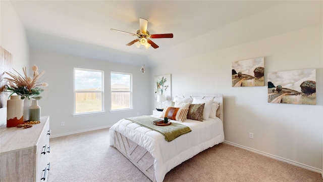 carpeted bedroom featuring ceiling fan and vaulted ceiling