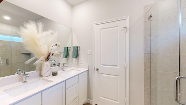 bathroom with vanity and a shower with shower door