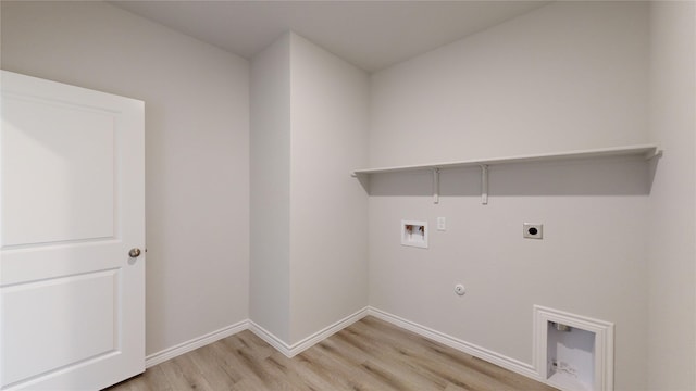 washroom featuring electric dryer hookup, hookup for a gas dryer, light hardwood / wood-style flooring, and washer hookup