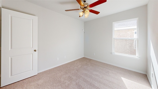 spare room featuring ceiling fan and light colored carpet