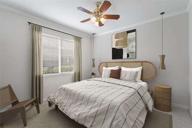 carpeted bedroom with ceiling fan and crown molding