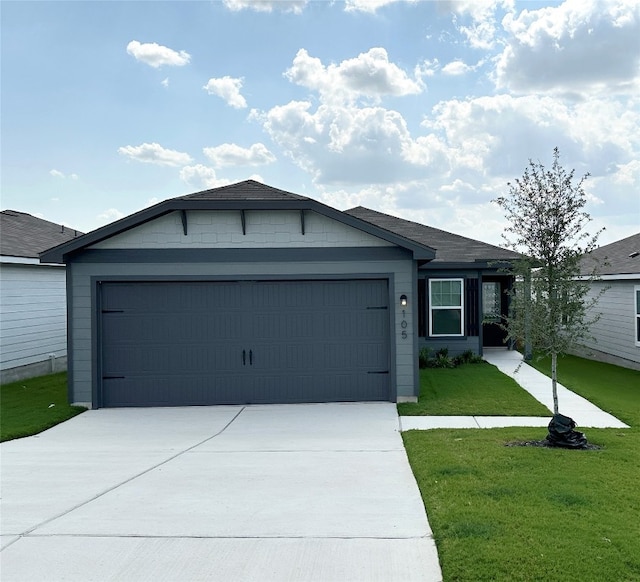 ranch-style home featuring a garage and a front lawn