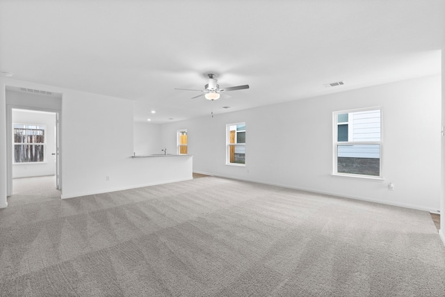 unfurnished living room with ceiling fan and light colored carpet