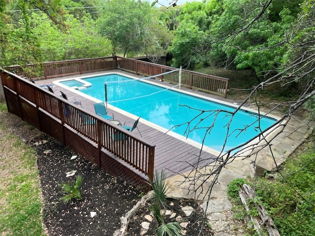 view of pool with an in ground hot tub