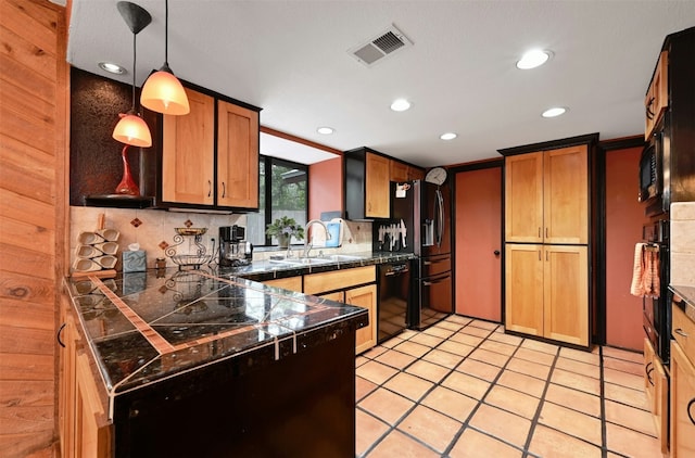 kitchen featuring decorative backsplash, sink, black appliances, decorative light fixtures, and light tile patterned flooring