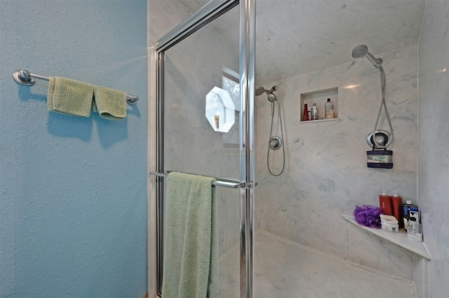 bathroom featuring a shower with door